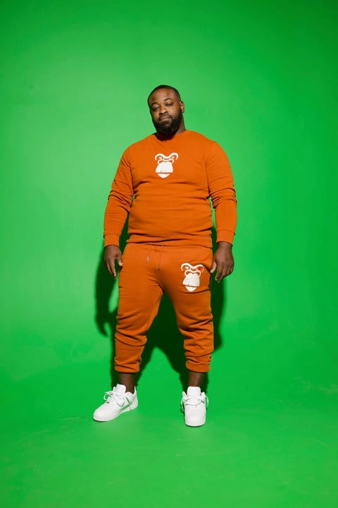 Man in orange tracksuit with bear logo