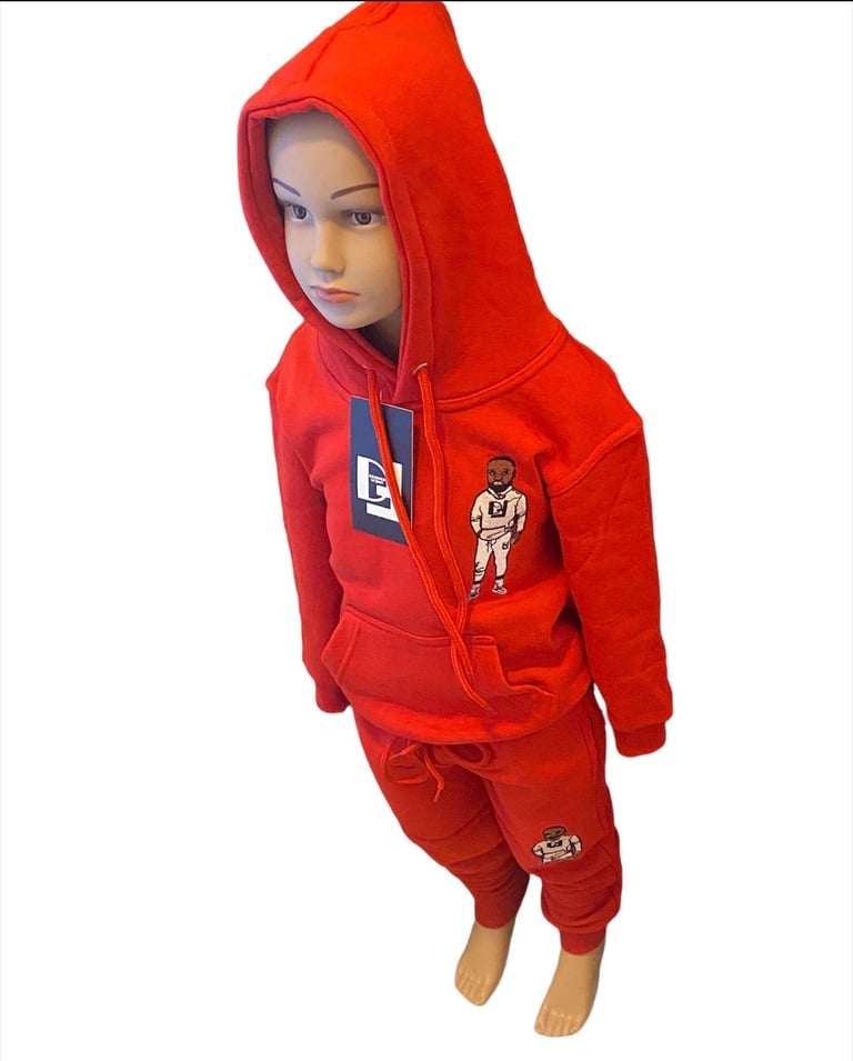 Child wearing red zip-up hoodie and matching red pants with graphic logos on white background